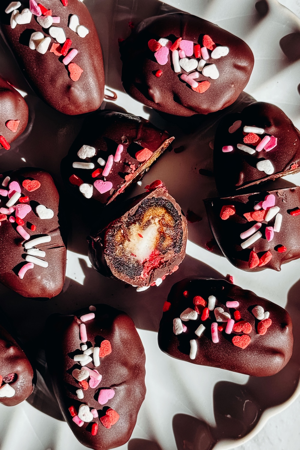 Raspberry cheesecake stuffed Medjool dates dipped in dark chocolate