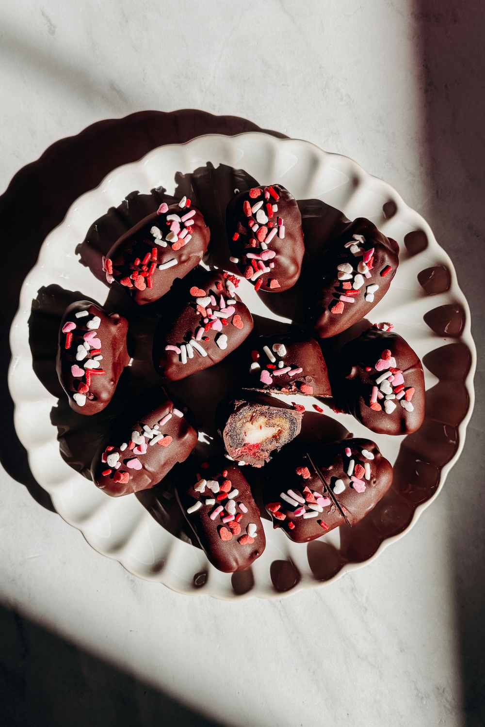 Raspberry cheesecake stuffed Medjool dates dipped in dark chocolate