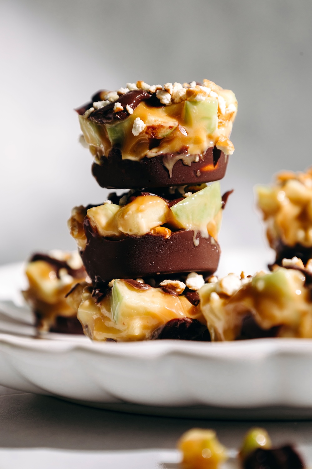 cross section of a caramel apple pretzel bite showing the chocolate pretzel base and apple caramel layers